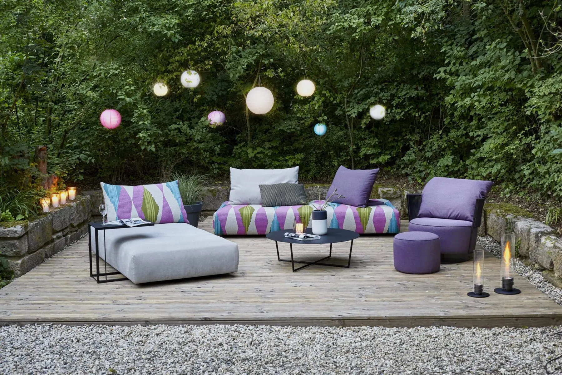 Outdoor-Modulsofa Iwan in Violett und Grau auf einer Terrasse
